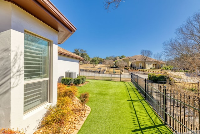 view of yard with fence and cooling unit