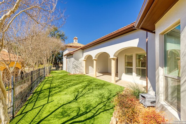 view of yard with fence and a patio
