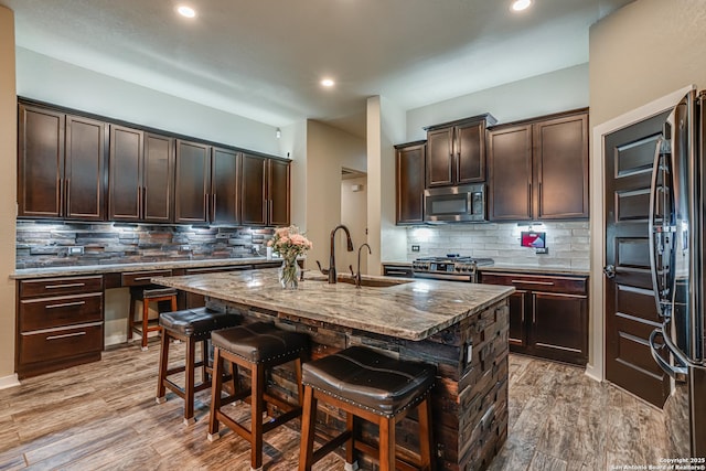12177 Tower Frst, San Antonio, TX 78253 - kitchen featuring backsplash, a kitchen breakfast bar, stainless steel appliances, and a sink