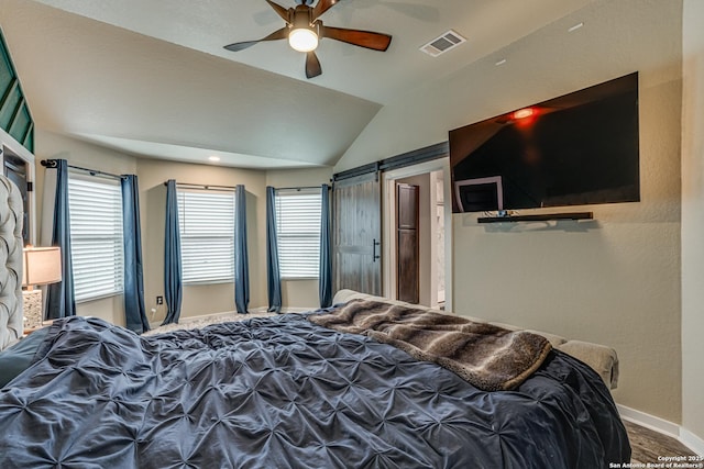 12177 Tower Frst, San Antonio, TX 78253 - bedroom featuring a barn door, vaulted ceiling, visible vents, a ceiling fan, and baseboards