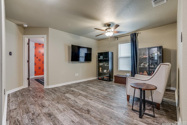 12177 Tower Frst, San Antonio, TX 78253 - living area with wood finished floors, visible vents, a ceiling fan, and baseboards