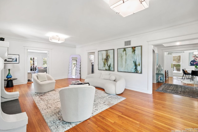 204 Parklane, Olmos Park, TX 78212 - living area featuring plenty of natural light, crown molding, light wood finished floors, and baseboards