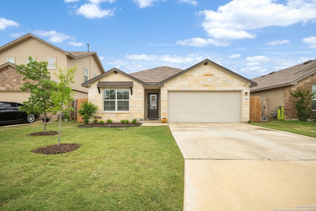 view of front of house with fence, a front lawn, concrete driveway, an attached garage, and stone siding