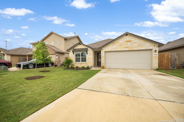 view of front of house featuring a garage, concrete driveway, stone siding, fence, and a front yard