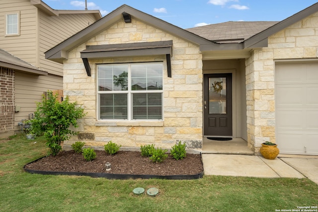 entrance to property featuring stone siding, a shingled roof, and a garage