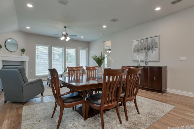 dining area with visible vents, light wood-style flooring, baseboards, and ceiling fan