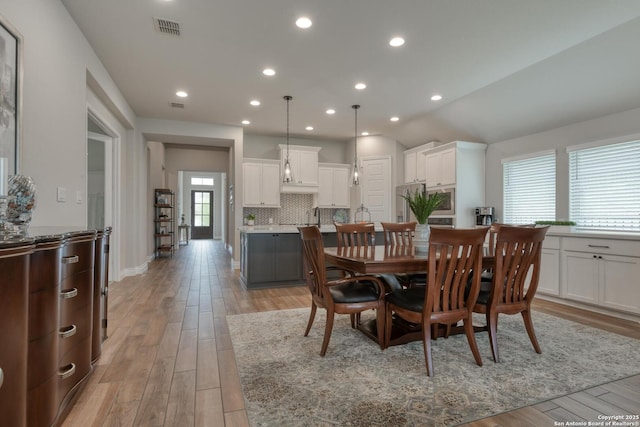 dining space with light wood-style flooring, visible vents, and recessed lighting