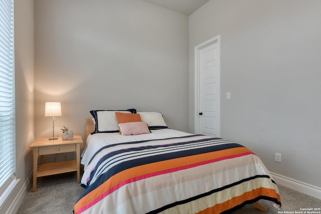 bedroom featuring baseboards and carpet