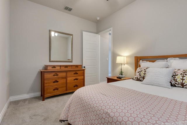 bedroom with light colored carpet, baseboards, and visible vents