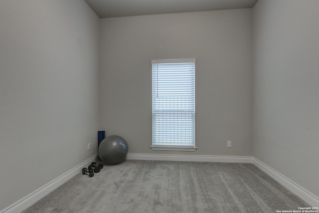 carpeted spare room with baseboards
