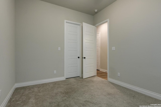 unfurnished bedroom with carpet floors and baseboards