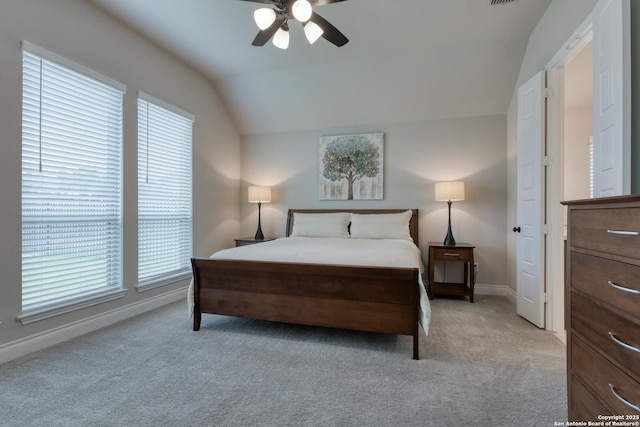 bedroom featuring light colored carpet, ceiling fan, vaulted ceiling, and baseboards