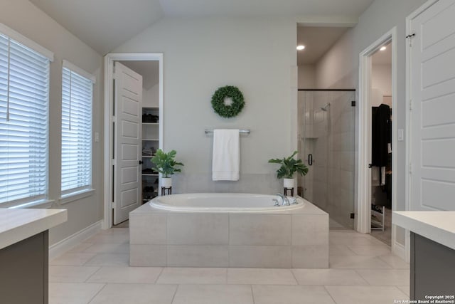 full bath with a bath, vanity, tile patterned floors, and a stall shower
