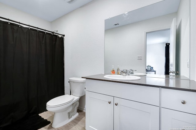 6057 Companion Loop, Bulverde, TX 78163 - full bathroom with wood finished floors, visible vents, toilet, vanity, and a shower with shower curtain