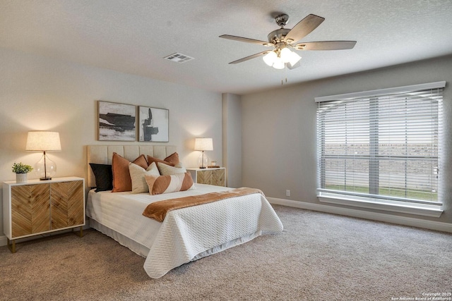 27314 Falls Cv, Boerne, TX 78015 - carpeted bedroom with a textured ceiling, visible vents, a ceiling fan, and baseboards