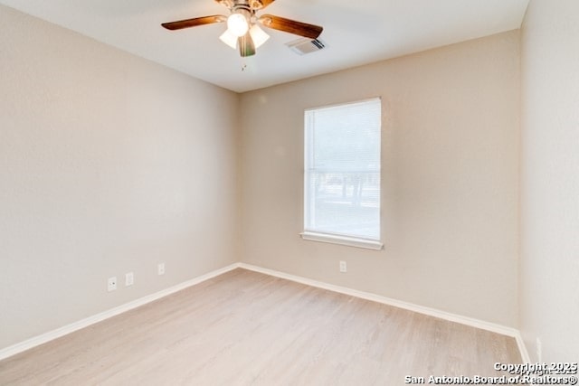unfurnished room with baseboards, visible vents, ceiling fan, and light wood finished floors