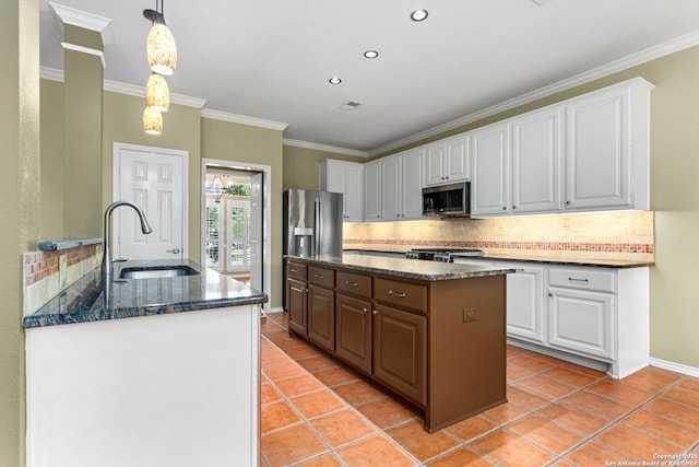 kitchen with stainless steel microwave, a sink, light tile patterned flooring, tasteful backsplash, and ornamental molding