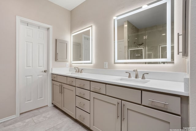 bathroom featuring double vanity, a sink, and a shower stall