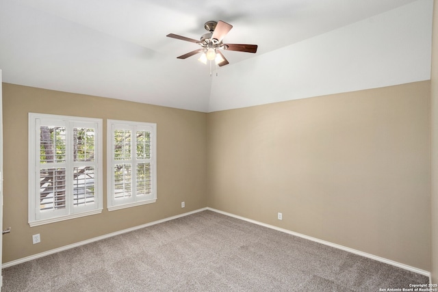 unfurnished room featuring a ceiling fan, carpet flooring, vaulted ceiling, and baseboards