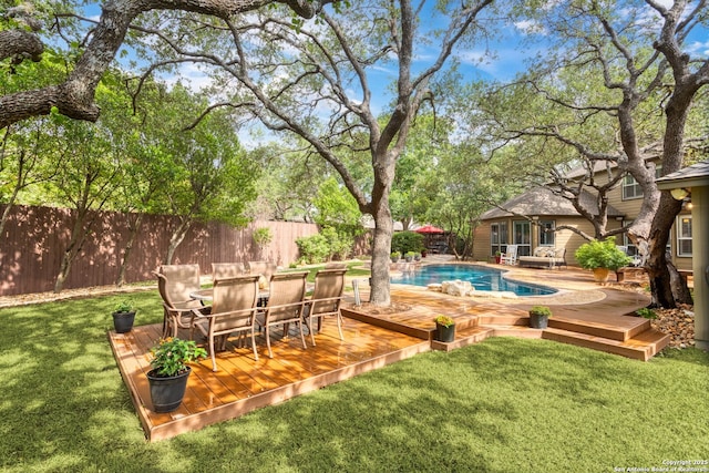 view of swimming pool featuring a wooden deck, a fenced in pool, and a fenced backyard