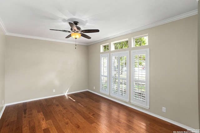 spare room with ceiling fan, crown molding, dark wood-style floors, and baseboards