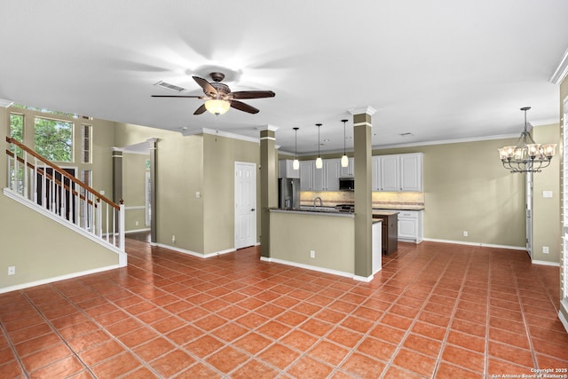 kitchen with decorative backsplash, stainless steel appliances, ceiling fan with notable chandelier, visible vents, and open floor plan