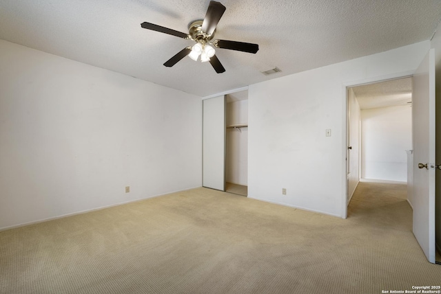 6635 Meadow Dawn, Converse, TX 78109 - unfurnished bedroom with a closet, visible vents, ceiling fan, and light carpet