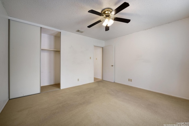 6635 Meadow Dawn, Converse, TX 78109 - unfurnished bedroom with a closet, ceiling fan, visible vents, carpet, and a textured ceiling