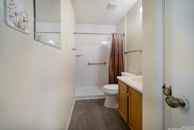 6635 Meadow Dawn, Converse, TX 78109 - full bathroom featuring a textured ceiling, curtained shower, toilet, wood finished floors, and vanity