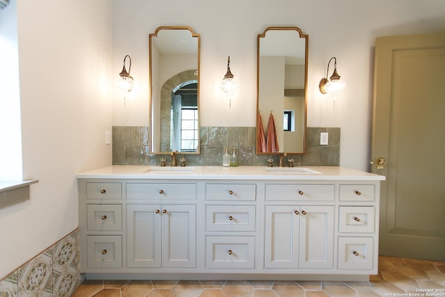 full bath with double vanity and a sink