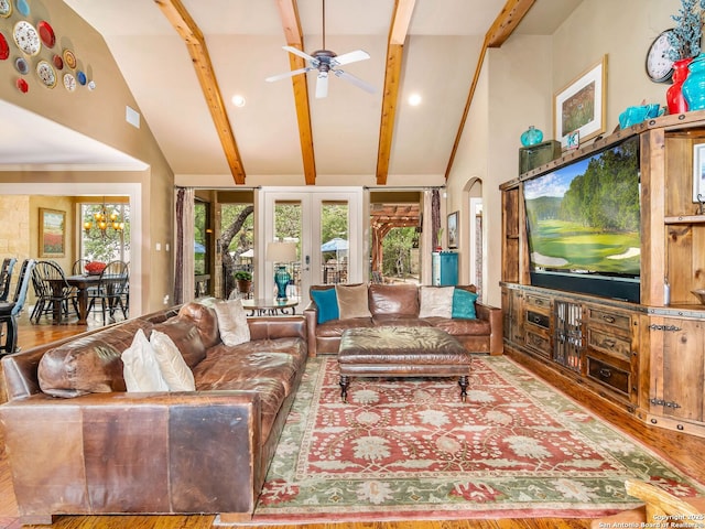 living area featuring wood finished floors, beamed ceiling, visible vents, a ceiling fan, and high vaulted ceiling