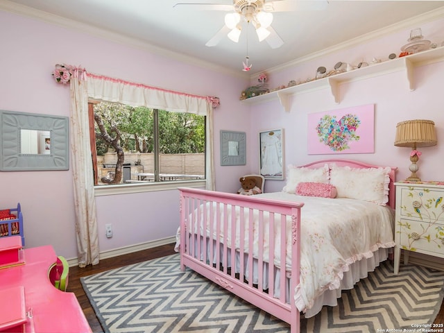 bedroom featuring crown molding, a ceiling fan, wood finished floors, and baseboards