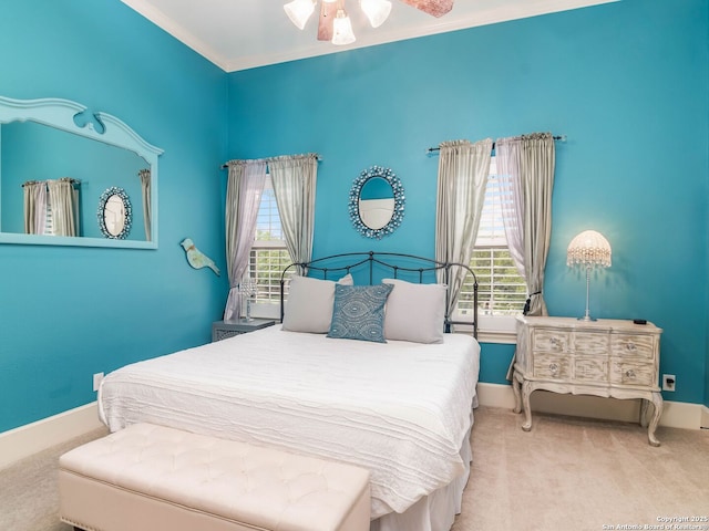 carpeted bedroom featuring multiple windows and baseboards