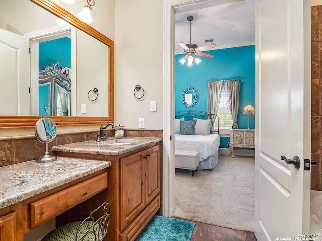 ensuite bathroom with visible vents, a ceiling fan, ensuite bath, and vanity