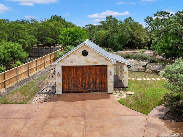 view of outbuilding featuring an outdoor structure and fence