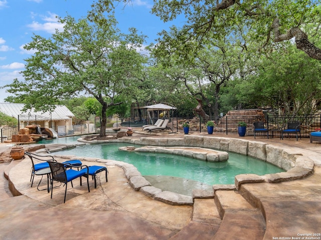 view of swimming pool with fence, a patio area, and a fenced in pool