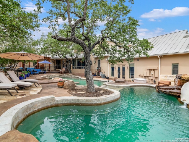 pool with a patio and french doors
