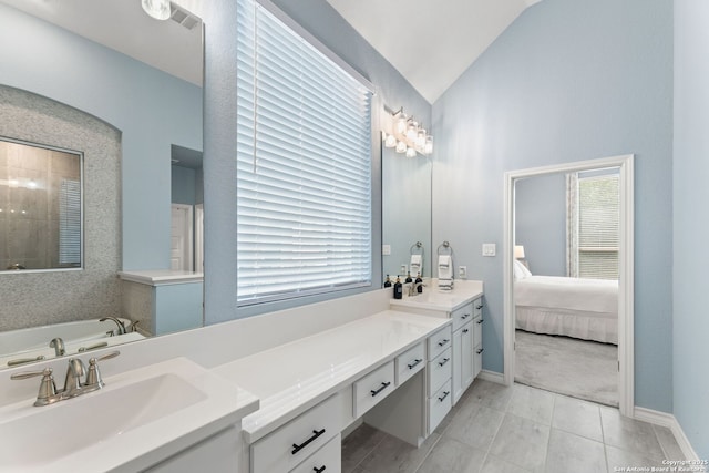 ensuite bathroom featuring a sink, ensuite bath, double vanity, a garden tub, and tile patterned flooring