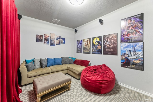 carpeted living area featuring a textured ceiling, visible vents, and baseboards
