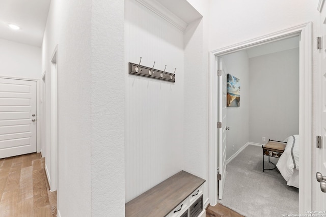 mudroom featuring baseboards and light wood-type flooring
