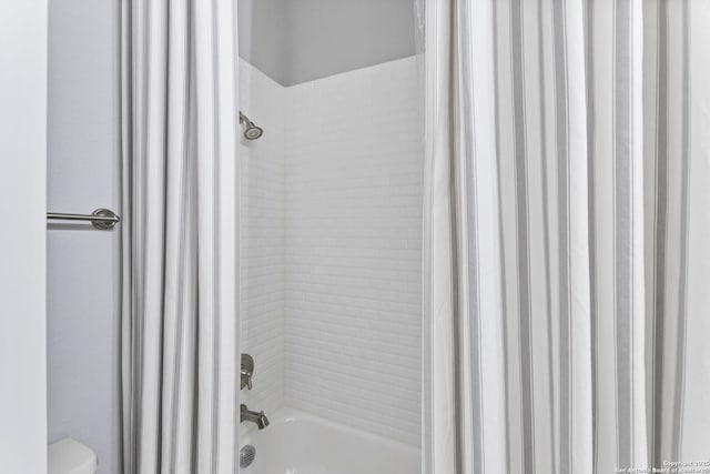 full bathroom with shower / tub combo with curtain and toilet