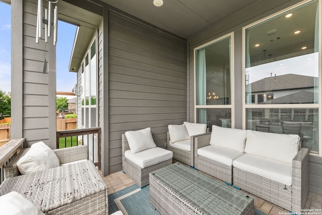 wooden terrace featuring an outdoor living space and fence