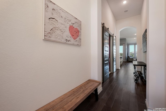 hall with recessed lighting, baseboards, dark wood finished floors, and arched walkways