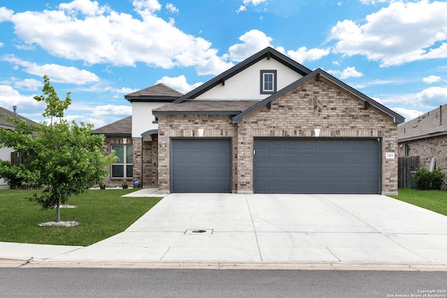 view of front of property with stucco siding, a front yard, concrete driveway, and an attached garage