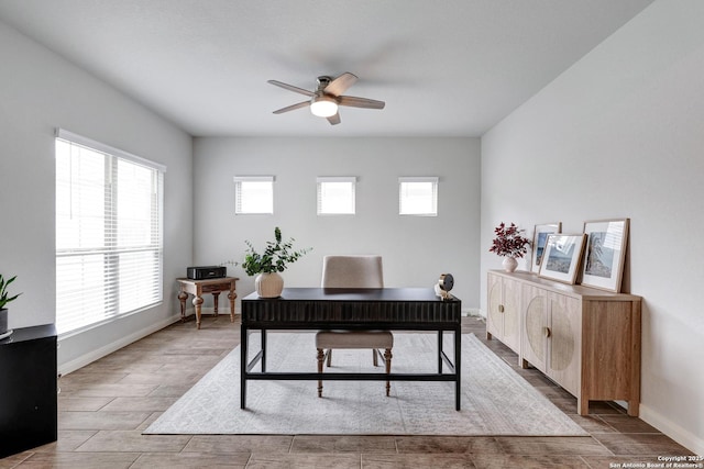 office space with baseboards, wood finished floors, and ceiling fan