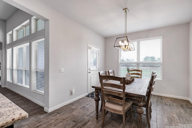 dining area with an inviting chandelier, baseboards, and dark wood finished floors