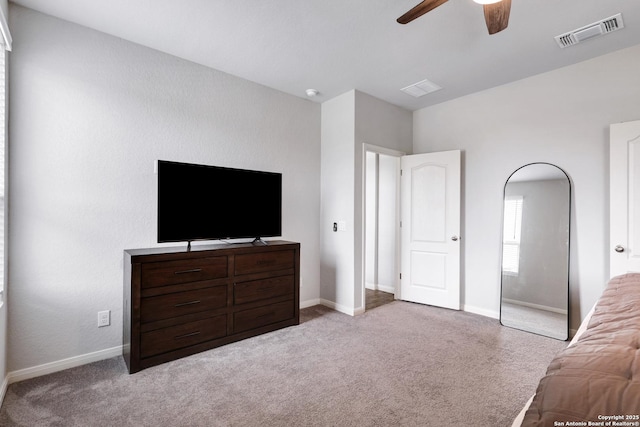 carpeted bedroom with visible vents, ceiling fan, and baseboards