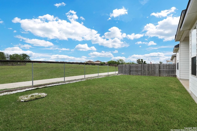 view of yard with a fenced backyard