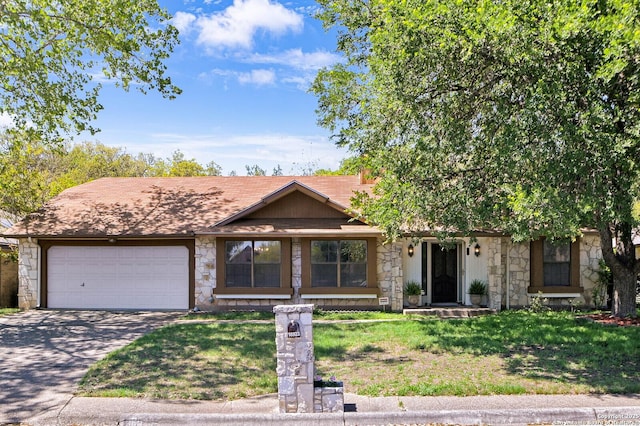 ranch-style house with concrete driveway, a front yard, an attached garage, and stone siding