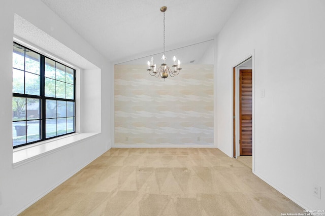 unfurnished dining area with a notable chandelier, lofted ceiling, and carpet floors